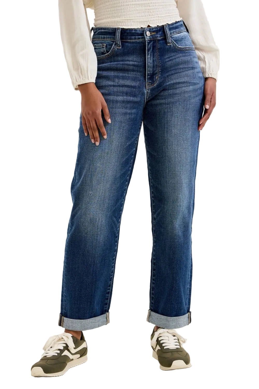 Person wearing blue jeans and a white top on a plain background