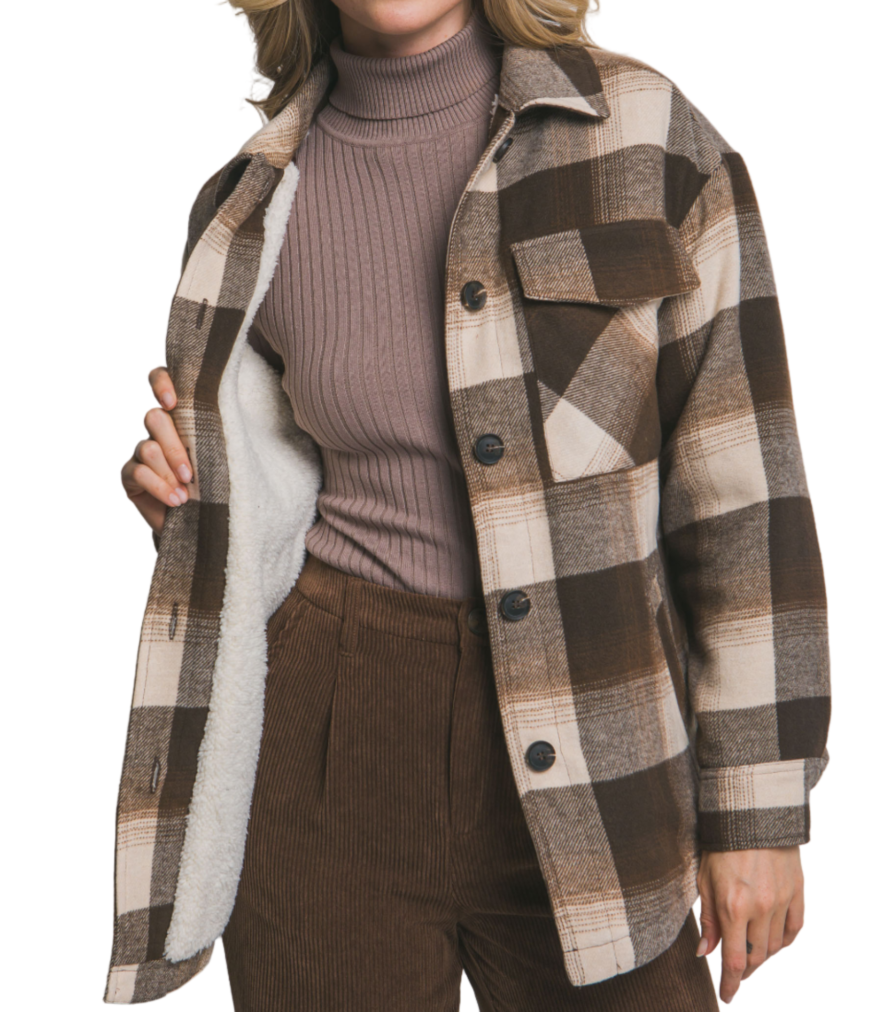 Woman wearing a plaid jacket over a sweater and pants on a plain background