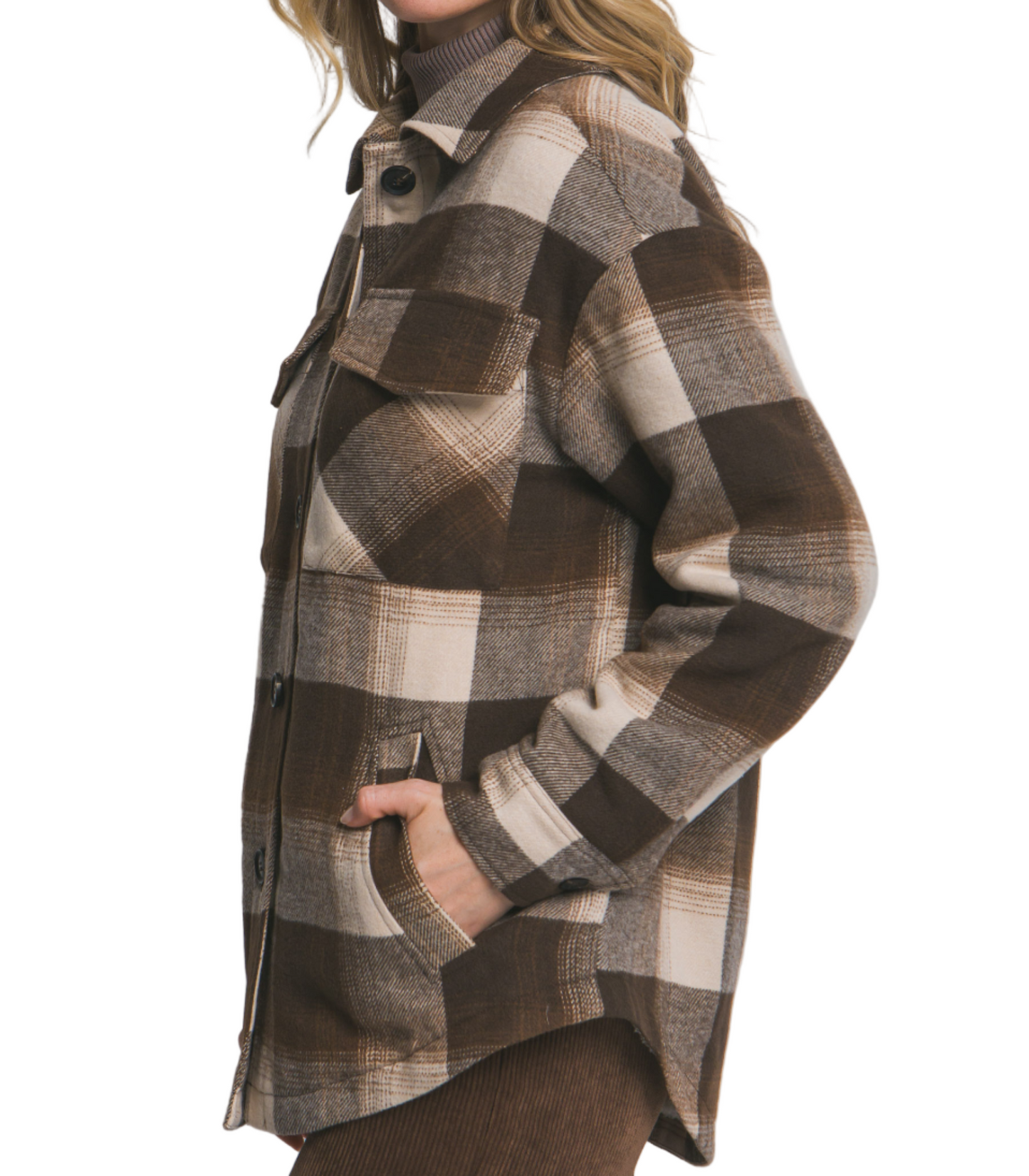 Woman wearing a plaid coat on a plain background