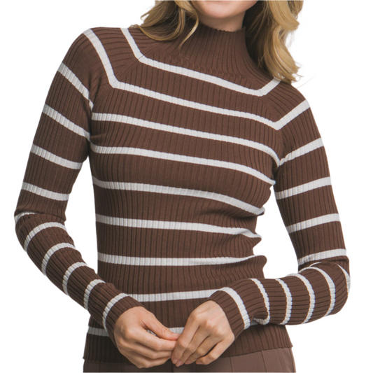Woman wearing a brown and white striped sweater against a plain background