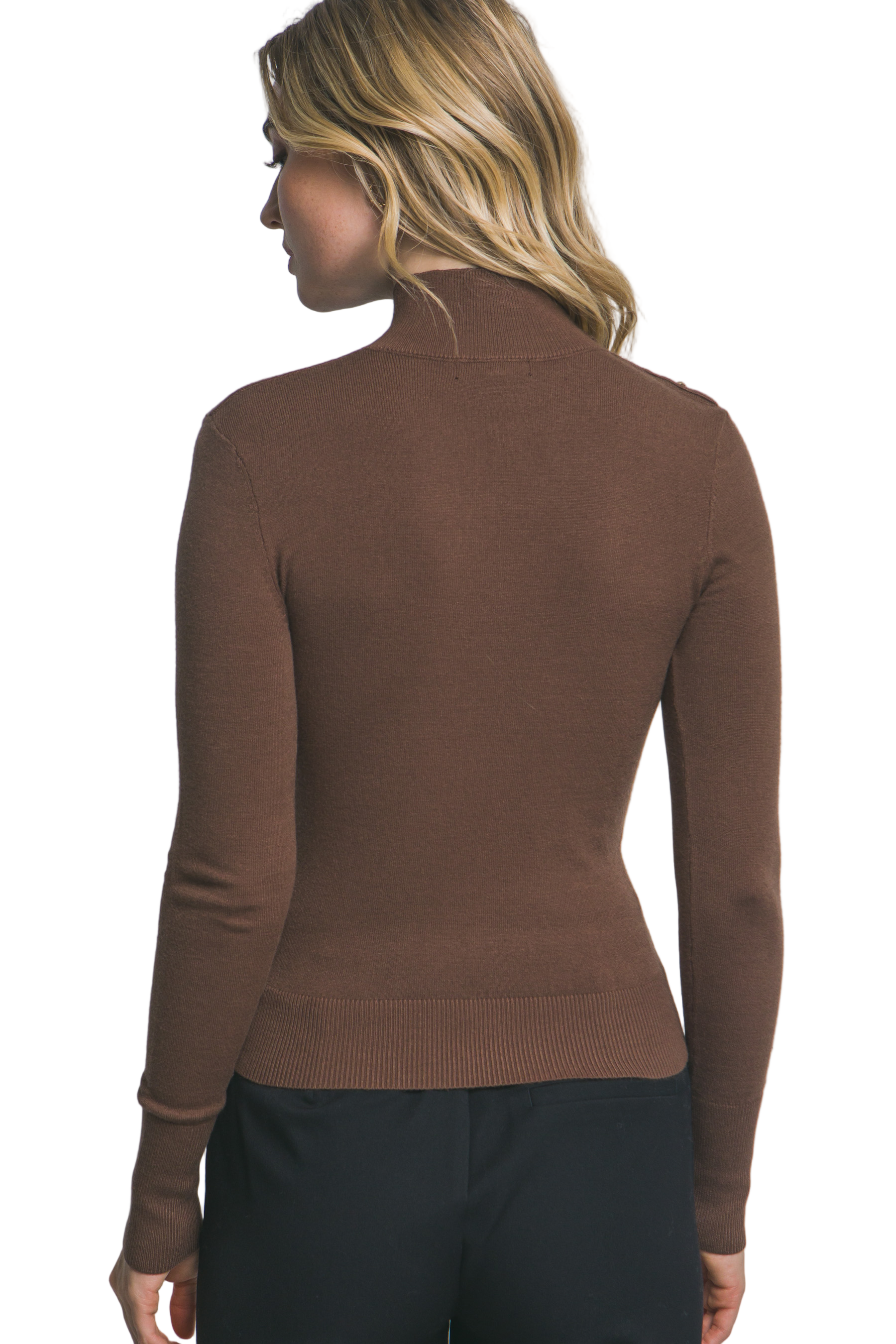 Woman wearing a brown sweater against a gray background