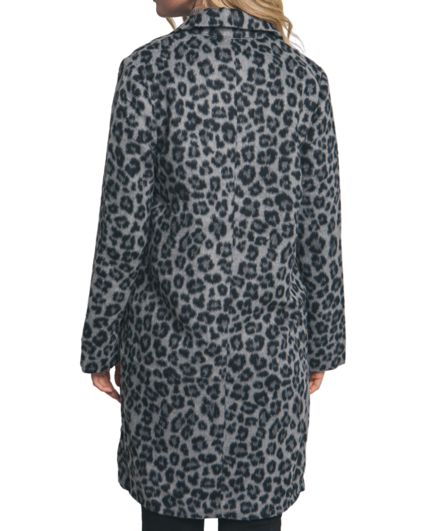 Person wearing a leopard print coat against a plain background
