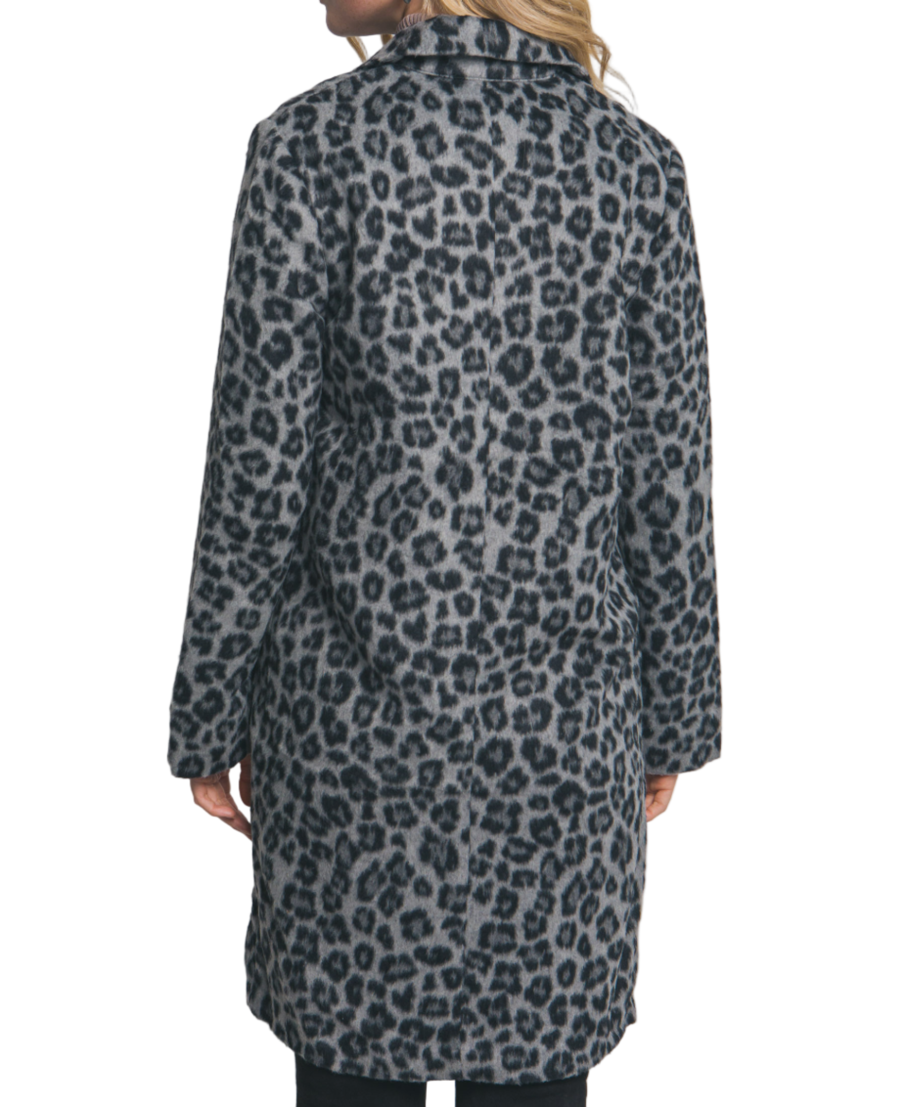 Person wearing a leopard print coat against a plain background