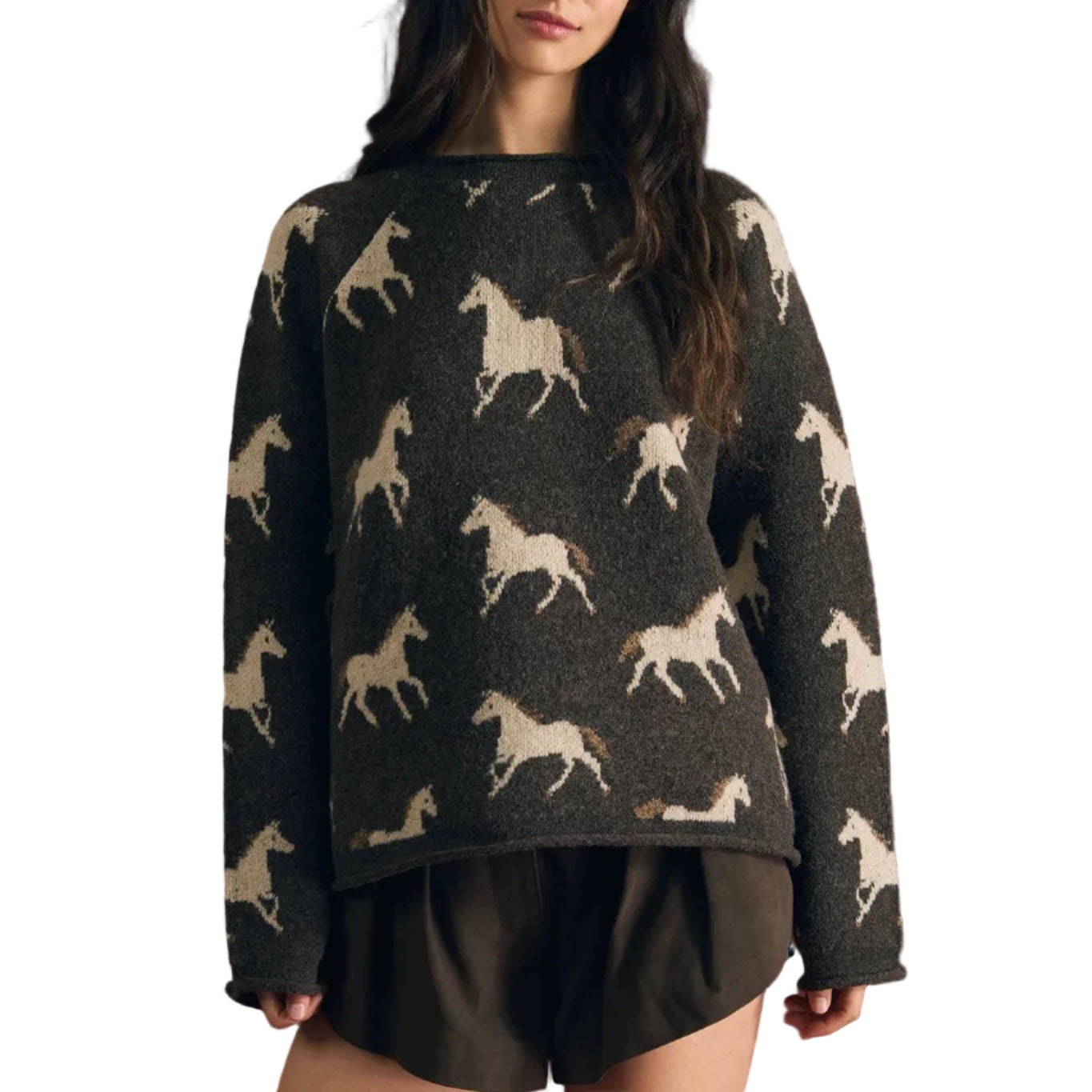 A woman modeling a dark charcoal knit sweater with a repeating cream horse pattern, paired with dark shorts, set against a solid dark red background.