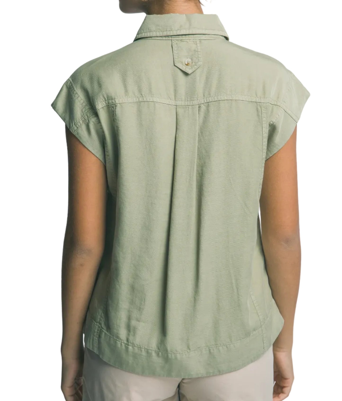 Person wearing a green sleeveless shirt against a plain background