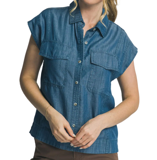 Woman wearing a blue denim shirt against a plain background