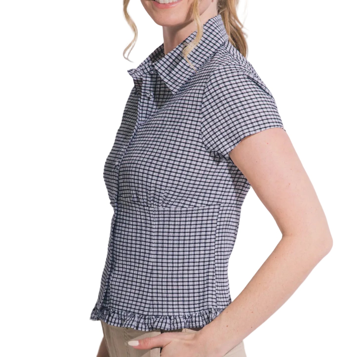 Woman wearing a checkered shirt with a plain background