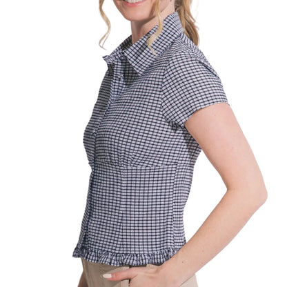 Woman wearing a checkered shirt with a plain background