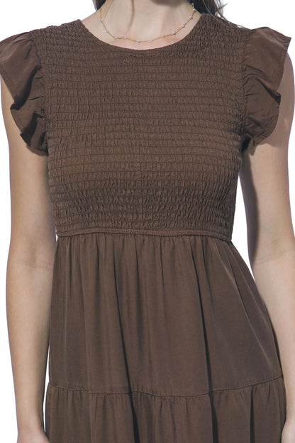 Brown dress with smocked bodice and plain background