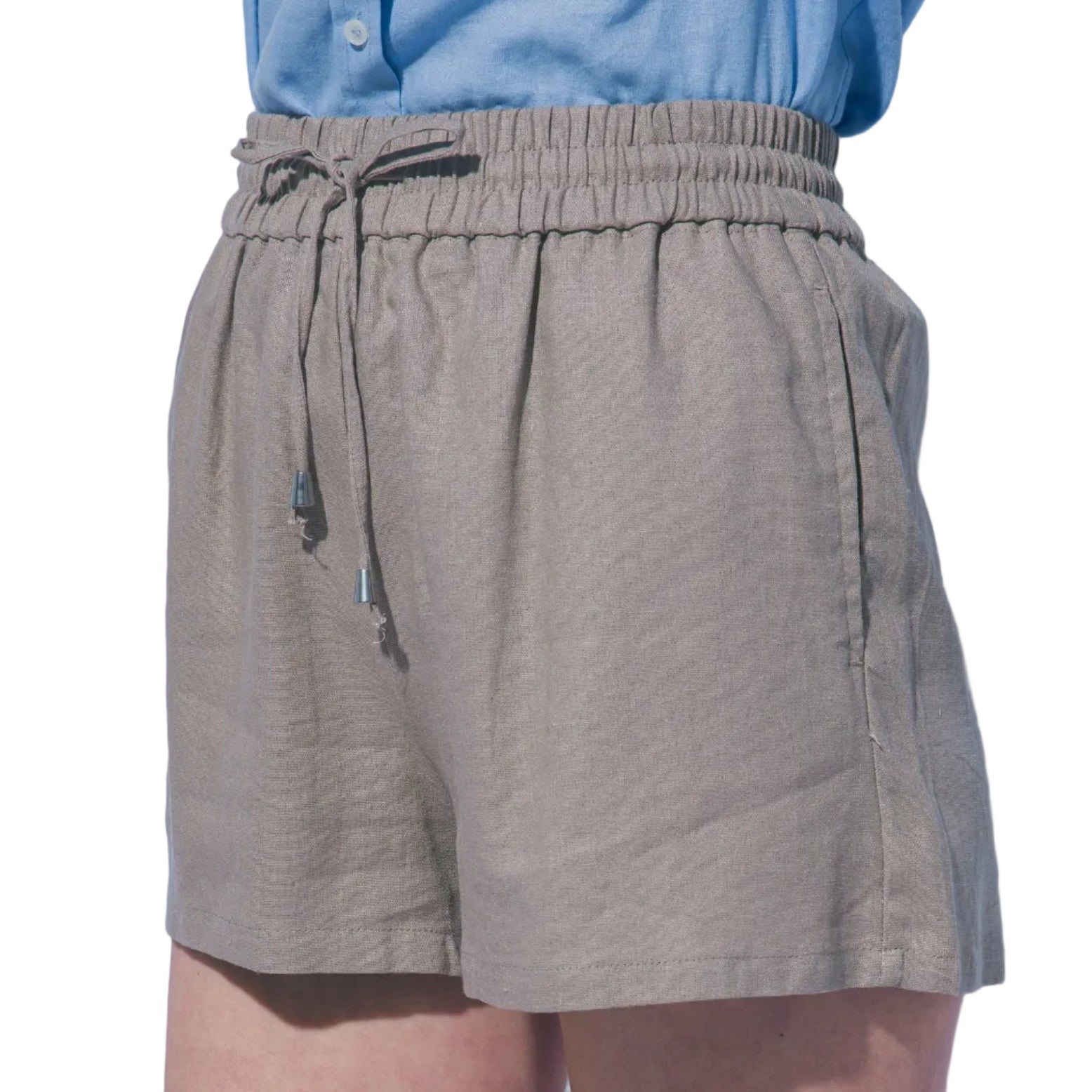 Person wearing beige shorts and a blue shirt against a light gray background