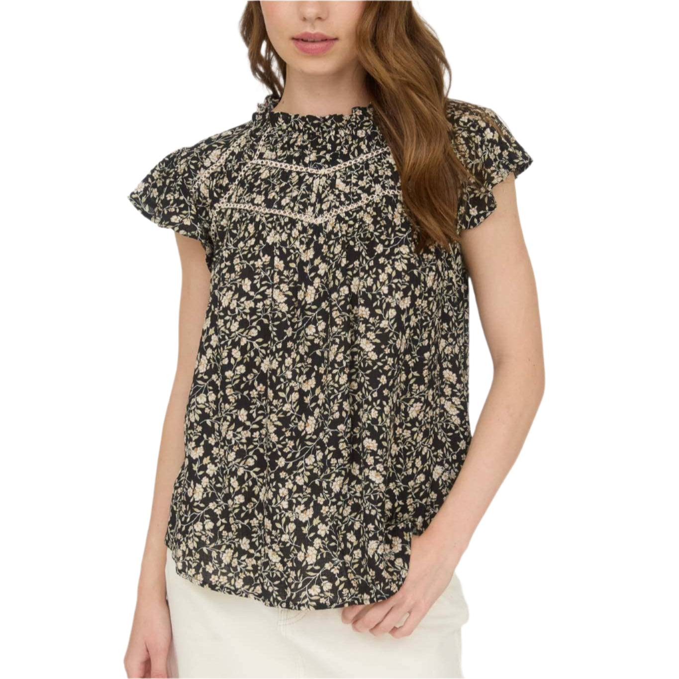 Woman wearing a floral blouse with a plain background