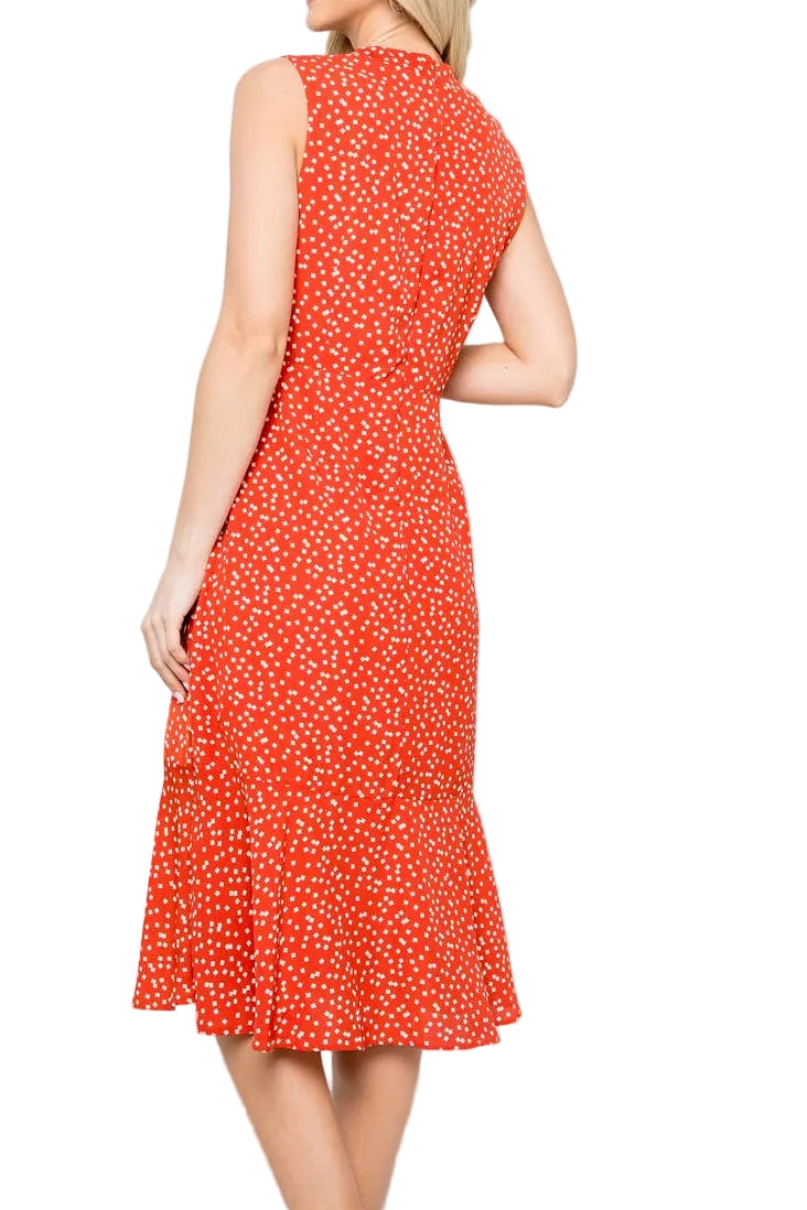 Woman wearing a red dress with white polka dots on a light gray background