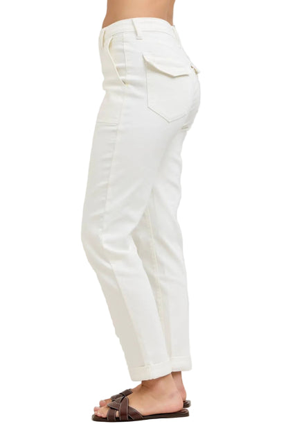 White pants worn by a person on a plain background