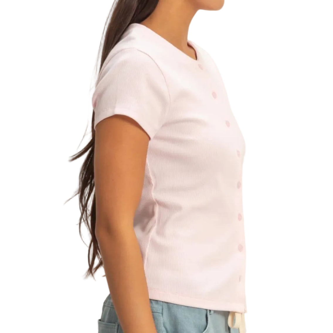 Woman wearing a white shirt and light blue shorts against a plain background