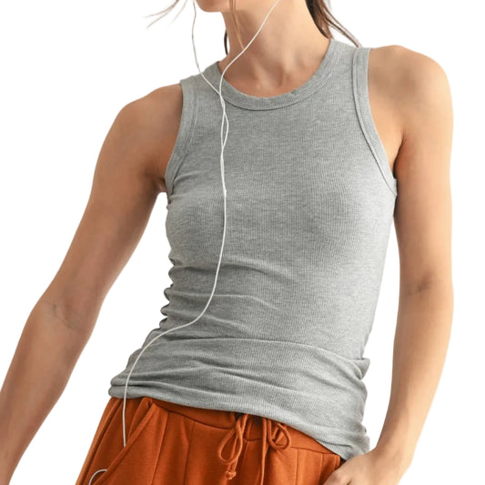 Woman wearing a gray tank top and orange pants, holding a water bottle with a white background