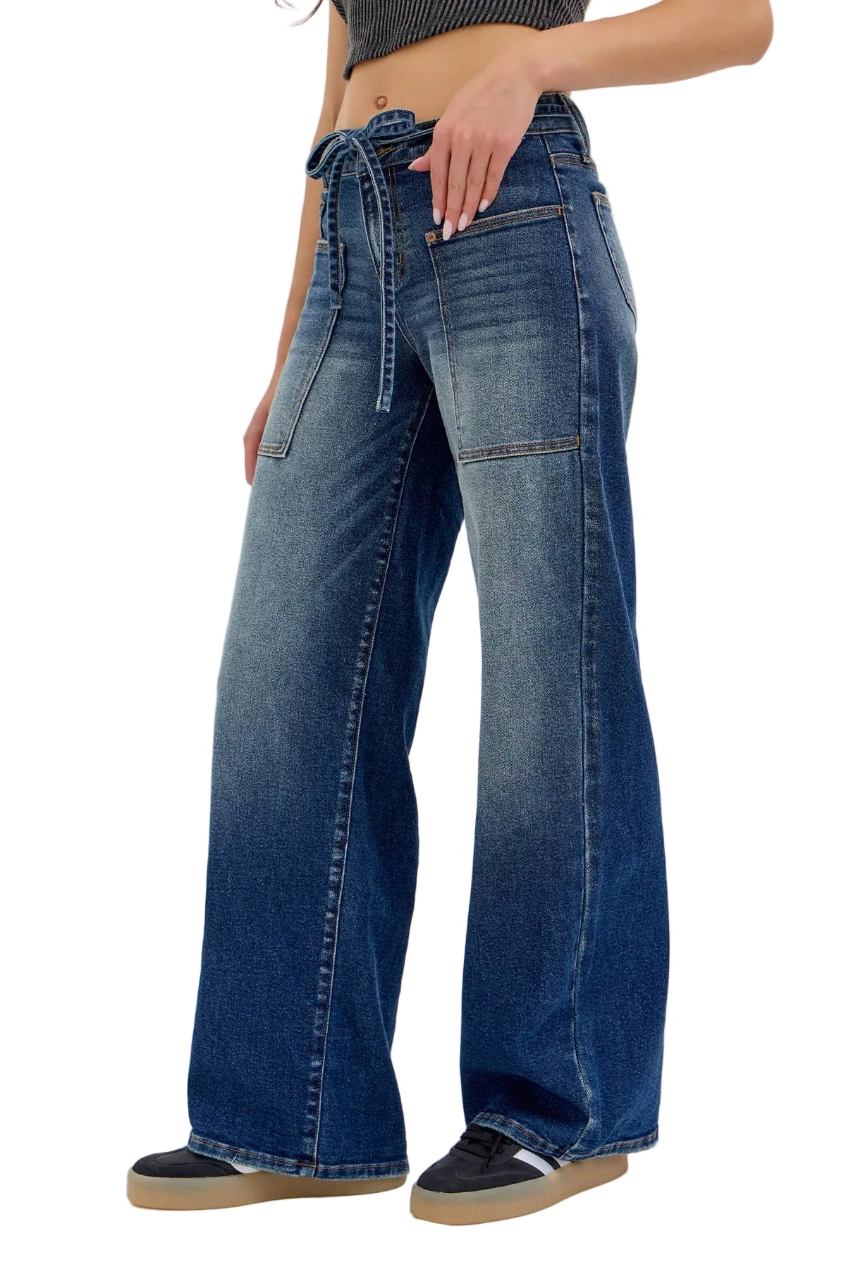 Blue jeans worn by a person on a white background