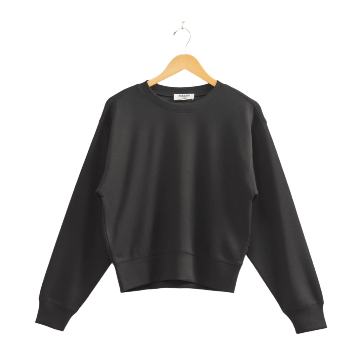 Black sweatshirt on a wooden hanger against a beige wall