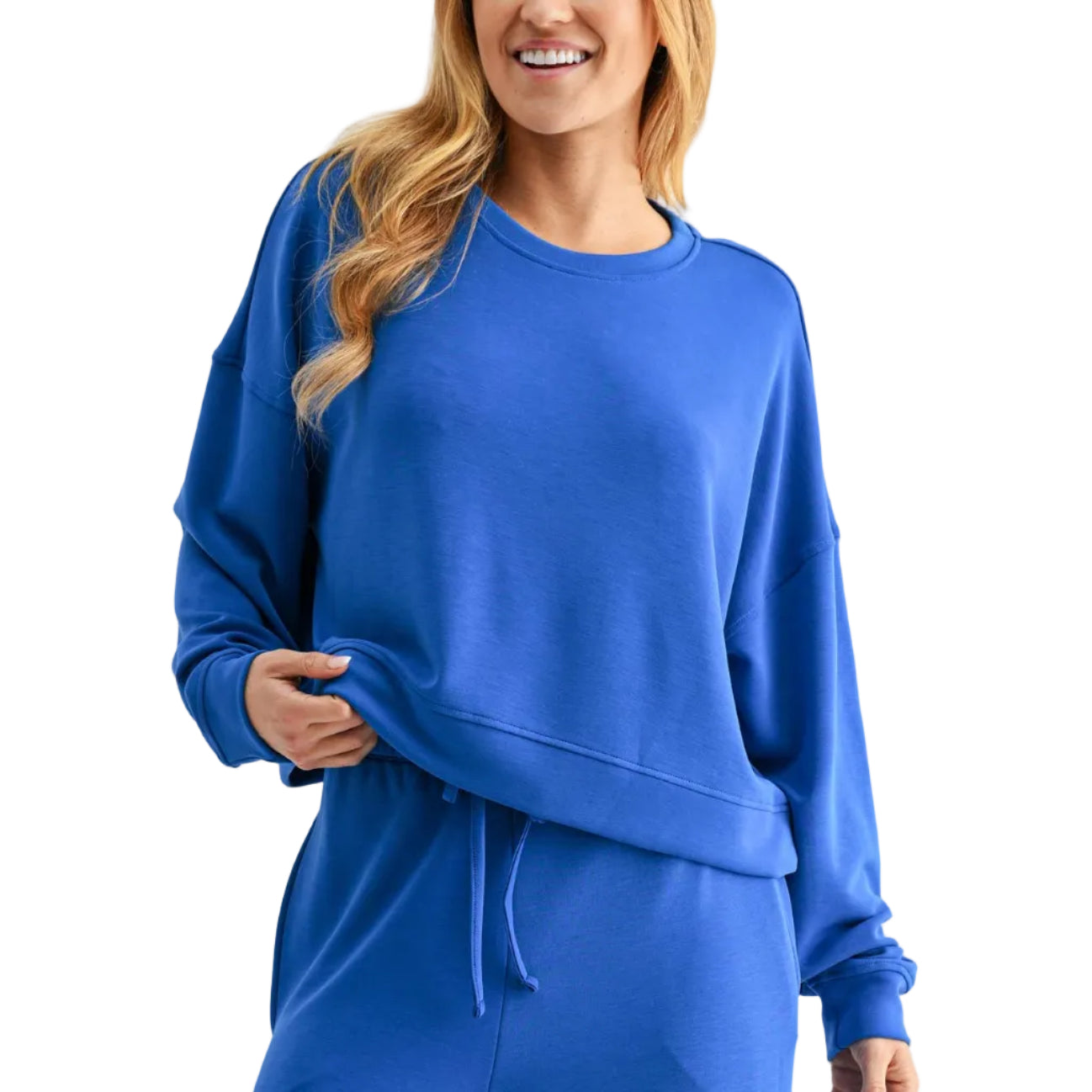 Woman wearing a blue tracksuit on a white background