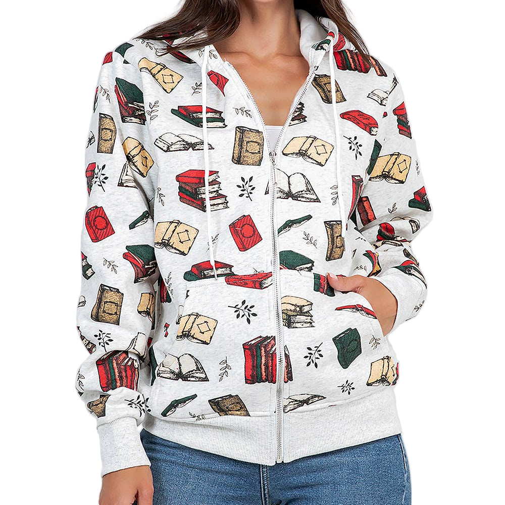 Woman wearing a white hoodie with book-themed design on a plain background