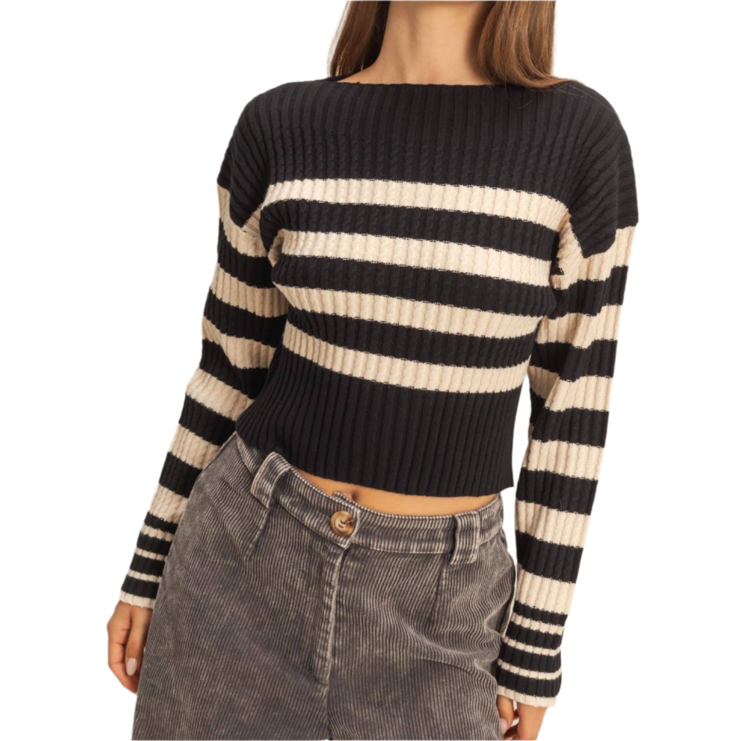 Woman wearing a black and white striped sweater with high-waisted gray pants on a beige background