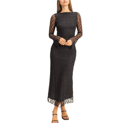 Woman wearing a black lace dress on a beige background