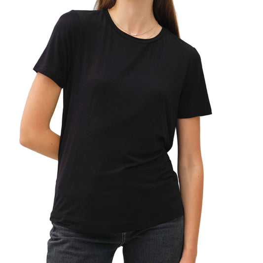 Woman wearing a black t-shirt against a plain background