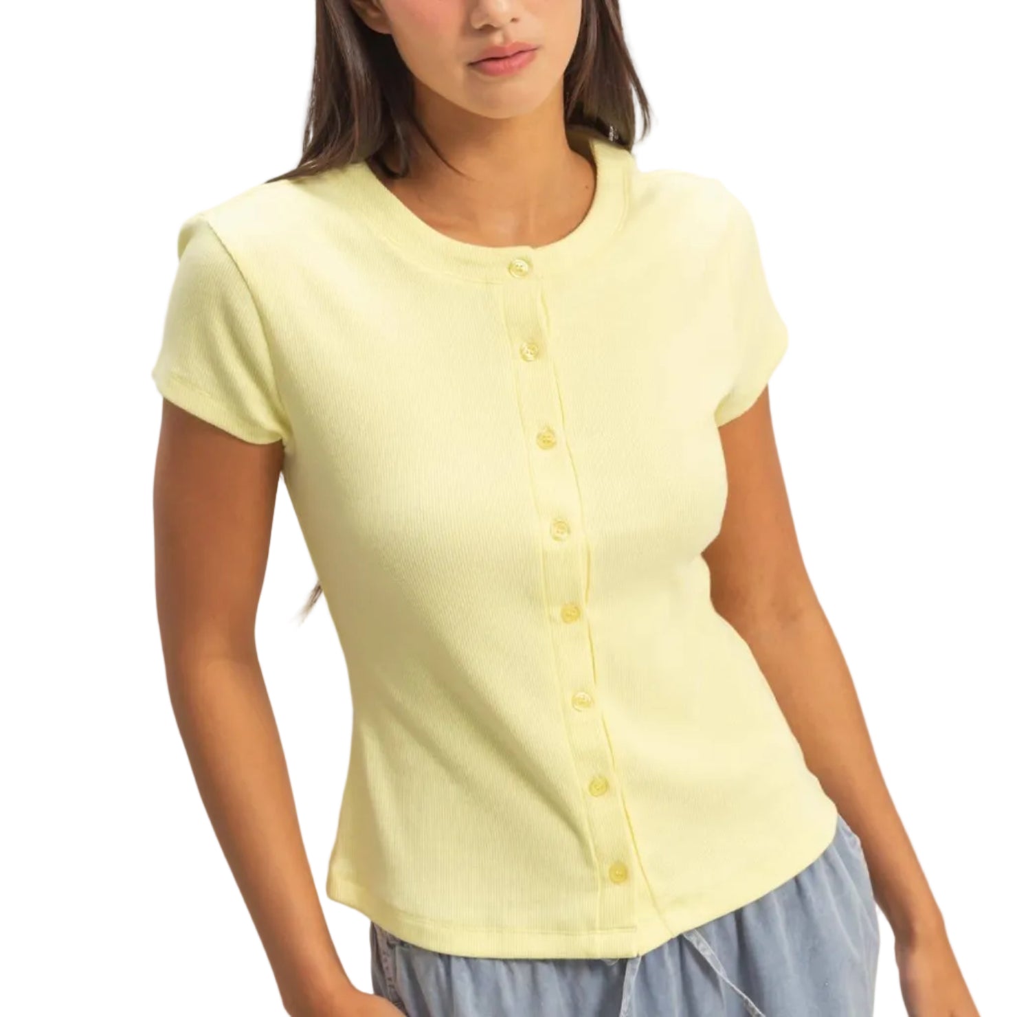 Woman wearing a light yellow short-sleeve shirt with buttons on a plain background