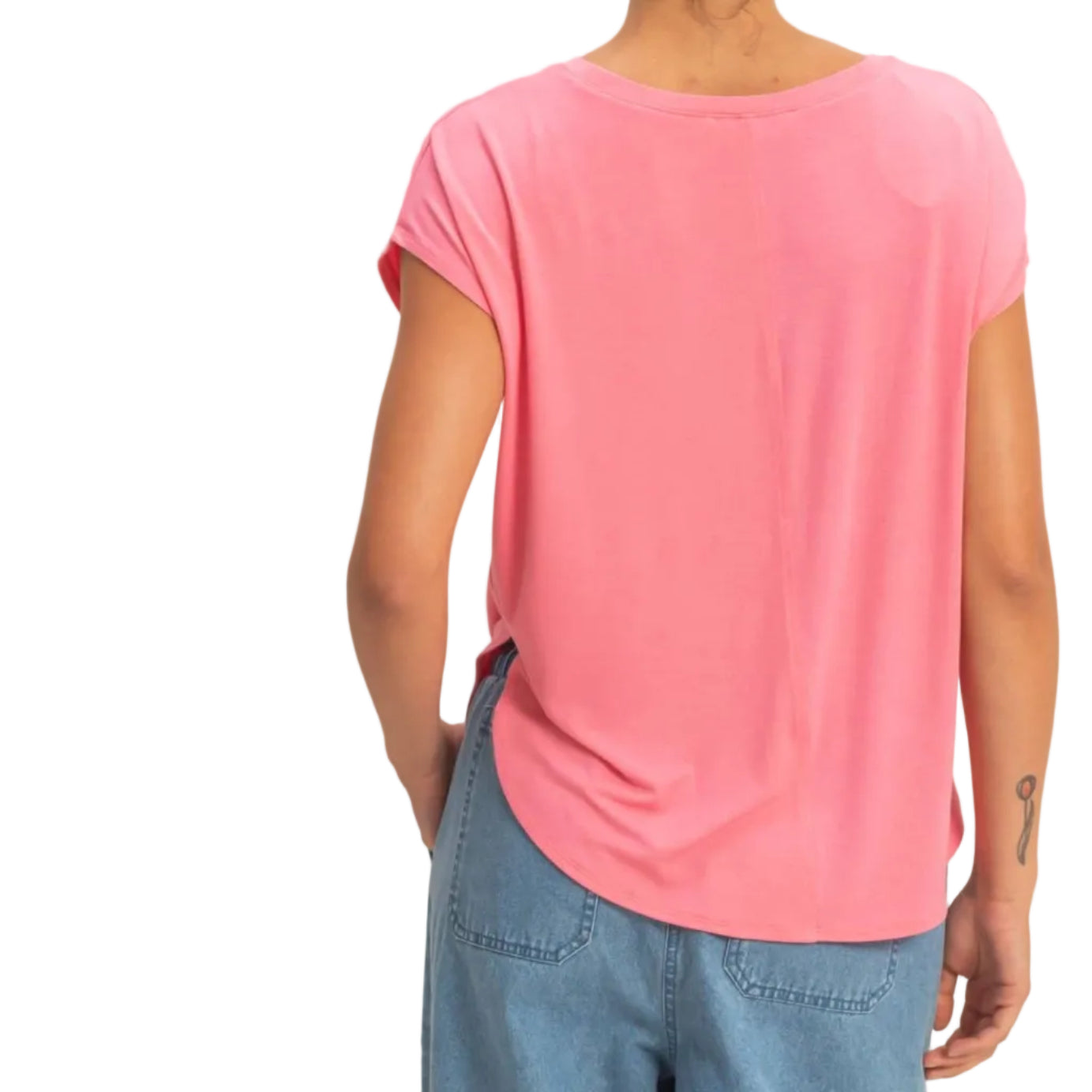 Person wearing a pink t-shirt and blue jeans on a beige background