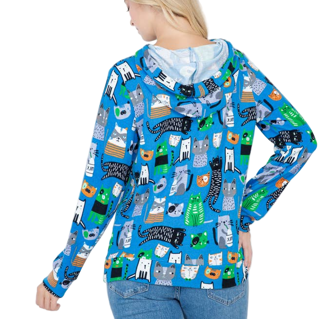 Person wearing a blue hoodie with cat pattern on a white background
