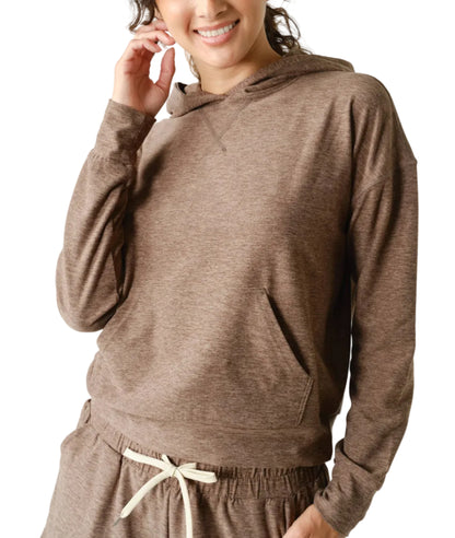 Woman wearing a brown hoodie and pants on a white background