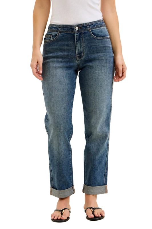 Person wearing blue jeans on a beige background