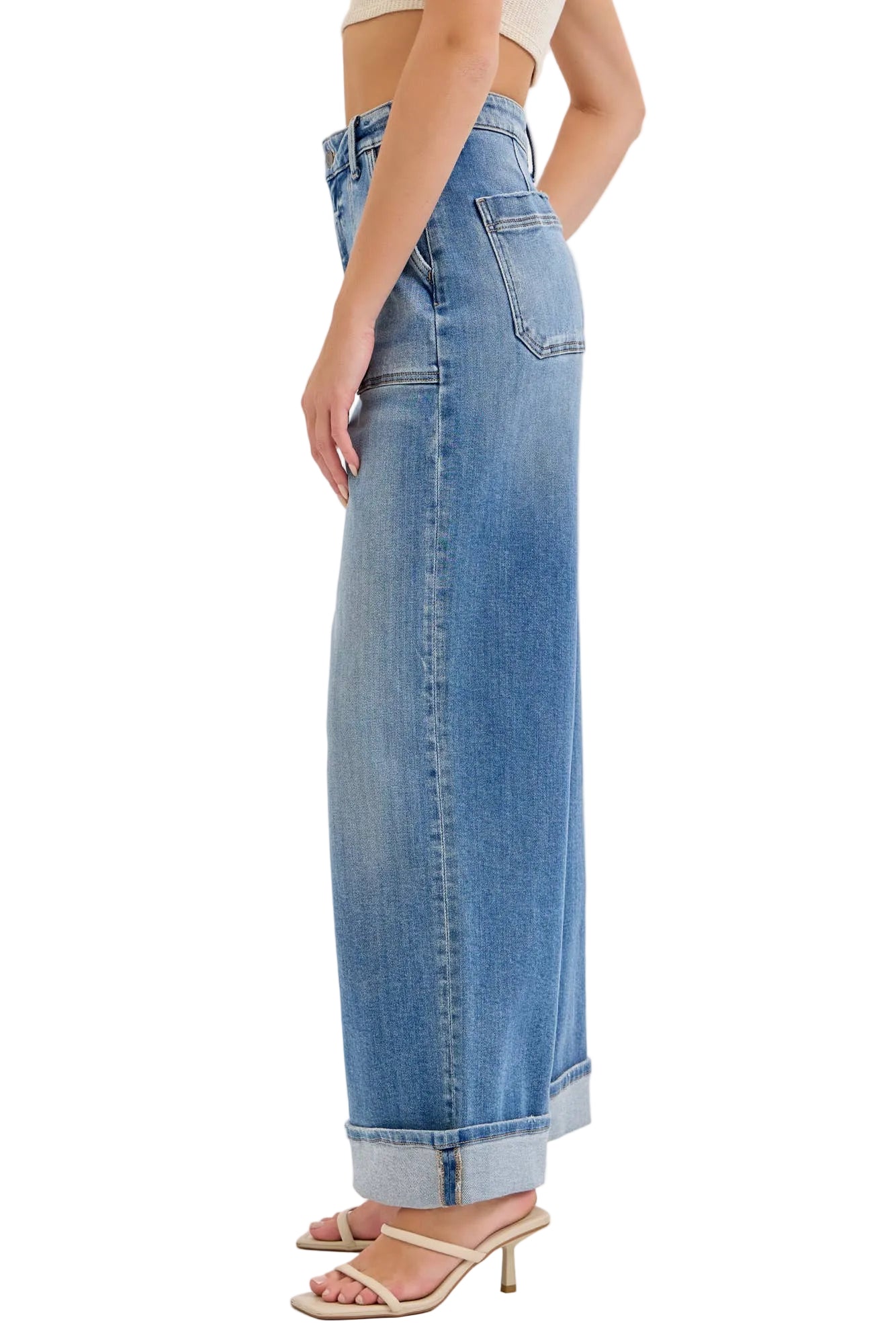 Woman wearing blue wide-leg jeans on a white background