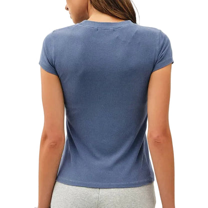 Woman wearing a blue t-shirt and gray shorts on a white background