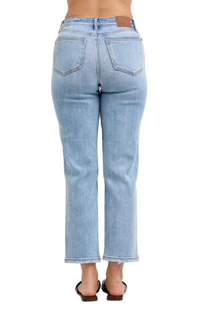 Light blue jeans worn by a person on a white background