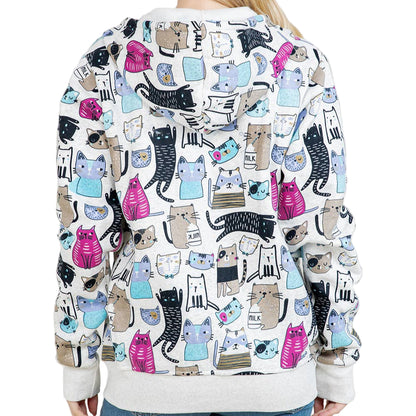 Person wearing a sweatshirt with a colorful cat pattern against a white background