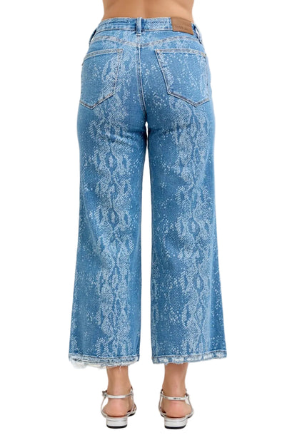 Blue acid-wash jeans worn by a person on a white background