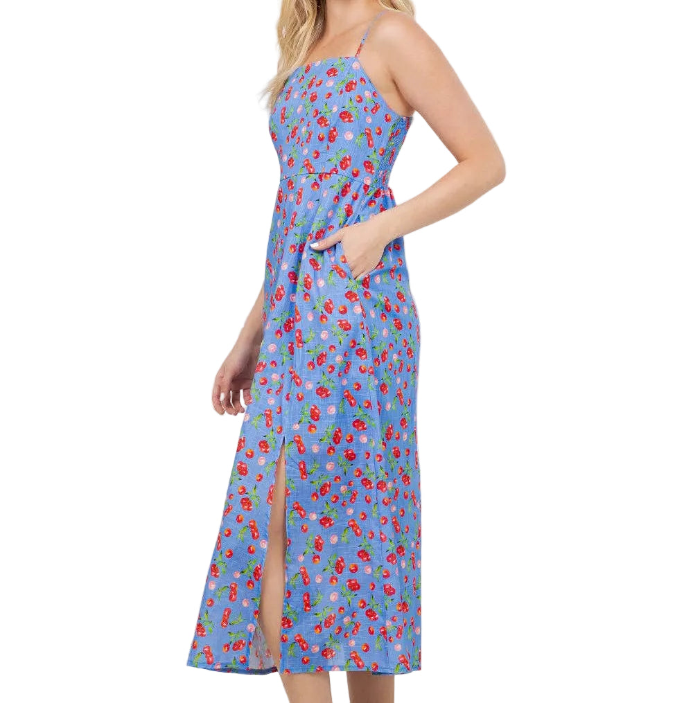 Woman wearing a blue floral dress in a room with plants