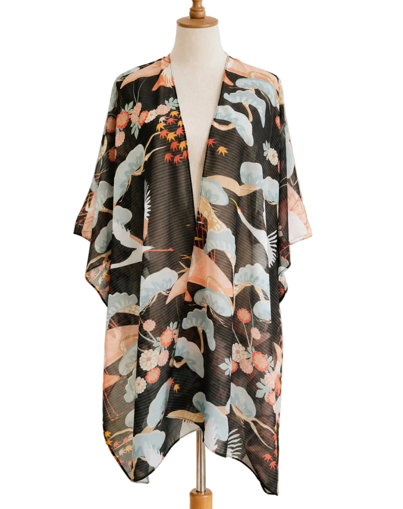 Floral kimono draped over a mannequin in a home setting