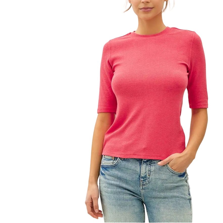 Woman wearing a pink top and light blue jeans on a white background