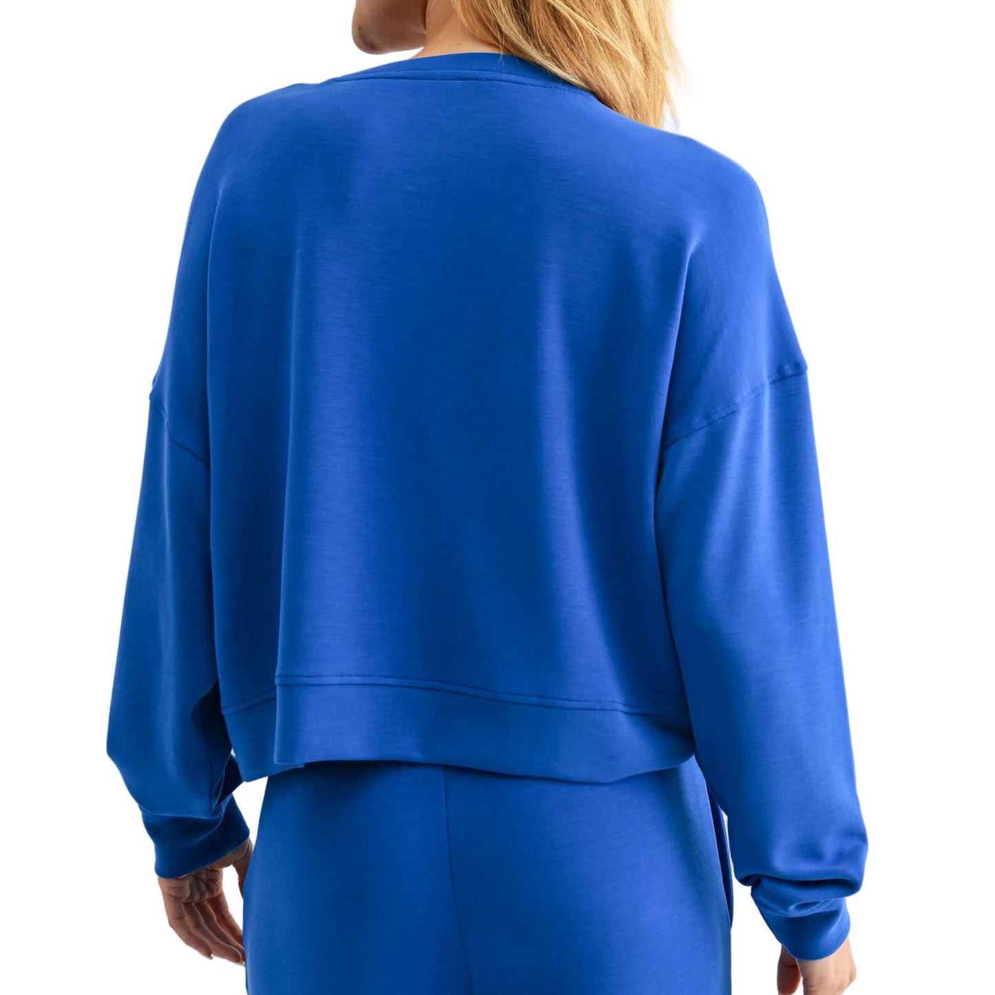 Person wearing a blue outfit on a plain background