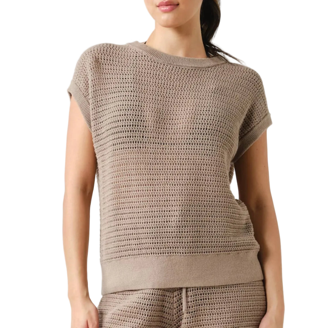 Woman wearing a brown knit top and shorts on a white background