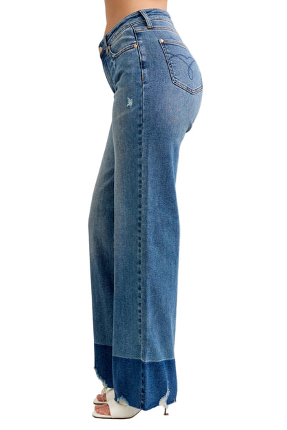 Blue jeans worn by a person on a white background