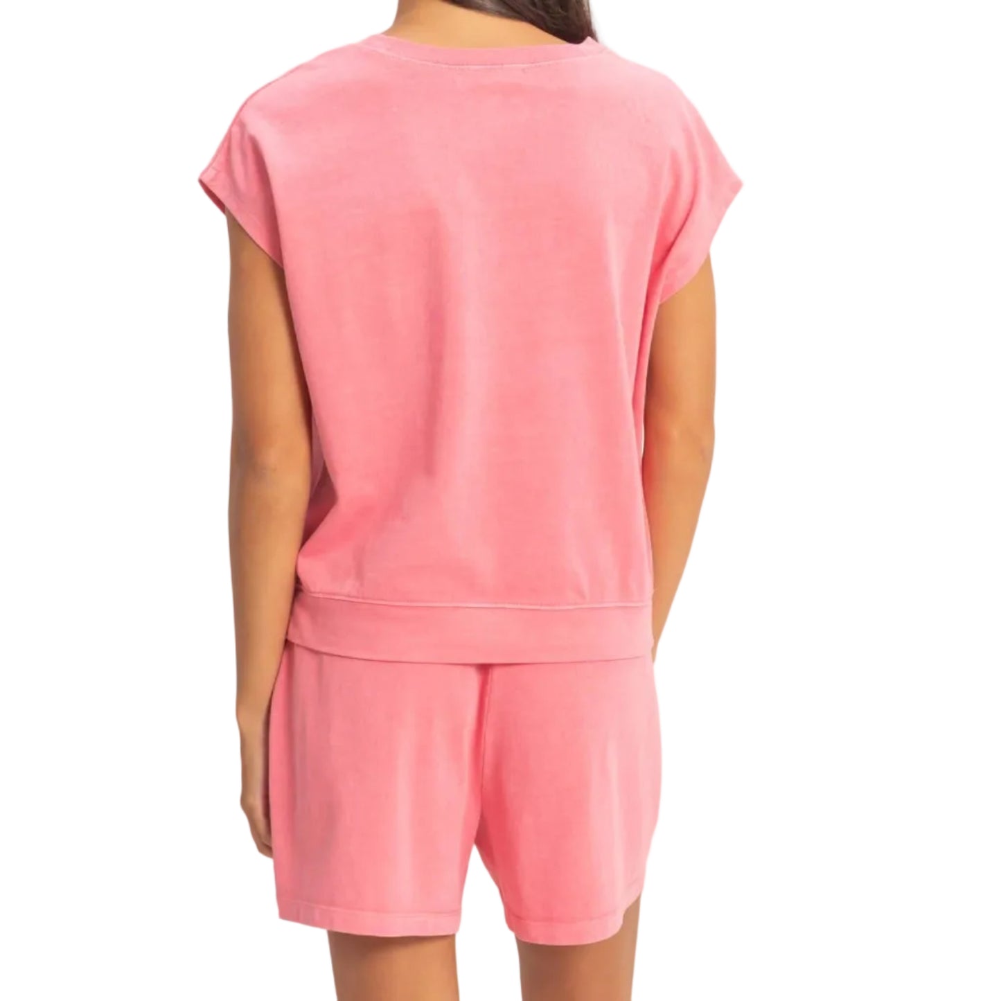 Person wearing a pink outfit on a plain background