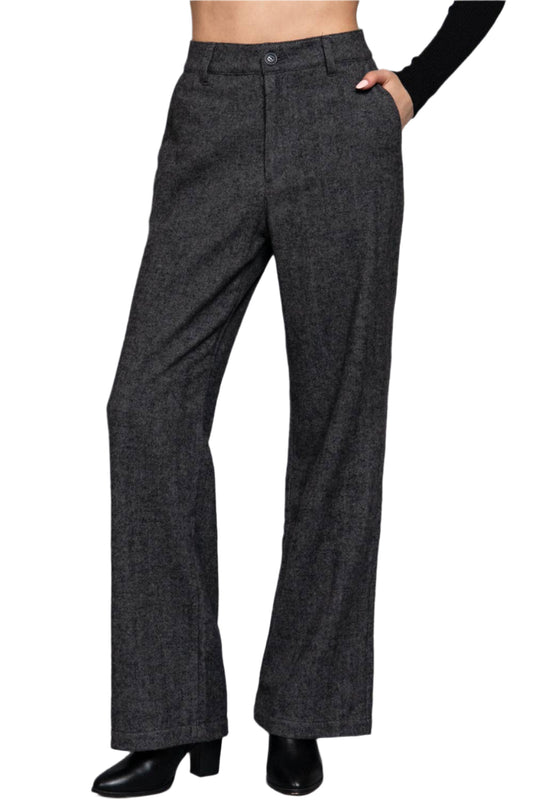 Dark gray flared pants on a plain background
