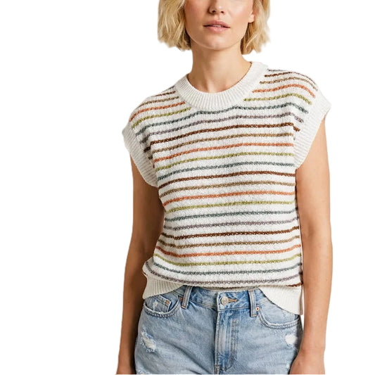 Woman wearing a colorful striped sleeveless sweater and jeans on a white background