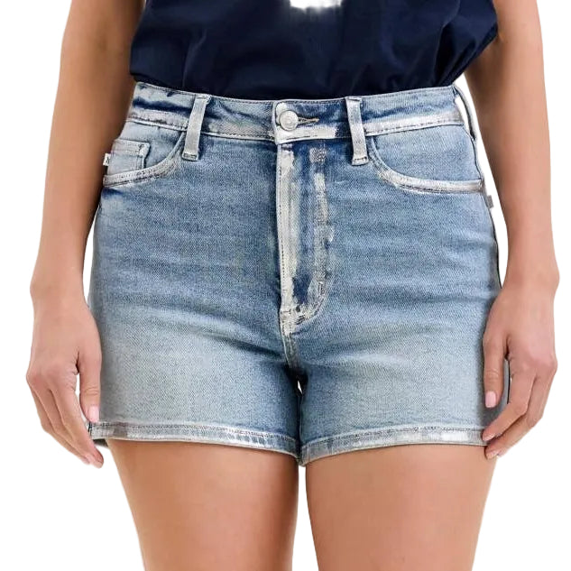 Denim shorts worn by a person on a plain background