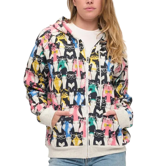 Person wearing a colorful patterned jacket and blue jeans on a white background