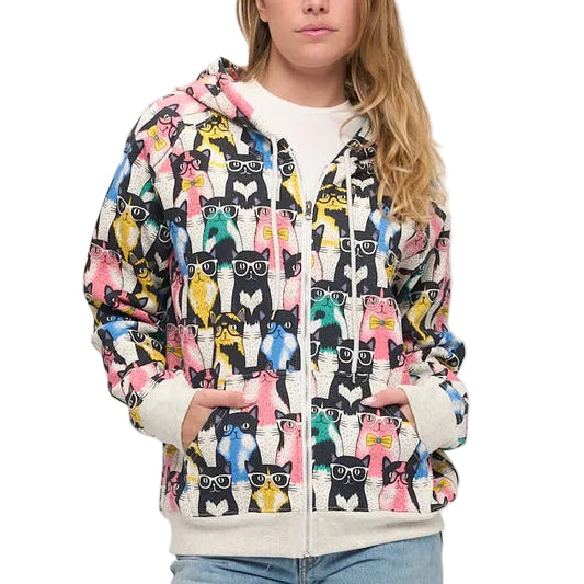 Person wearing a colorful patterned jacket and blue jeans on a white background