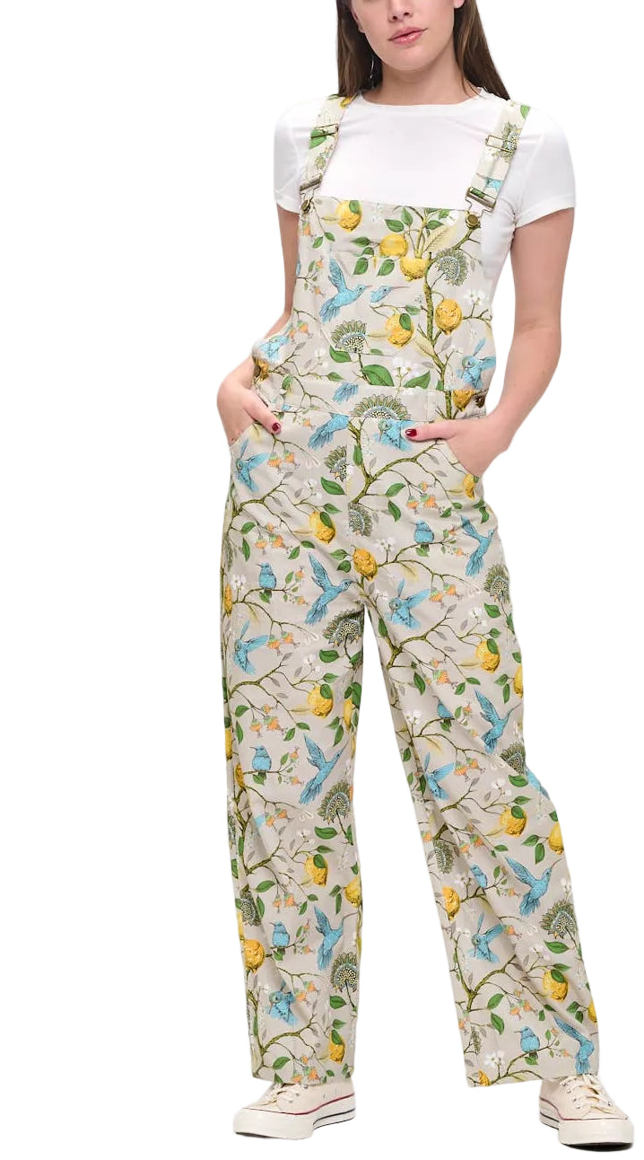 Woman wearing a floral patterned overalls on a white background