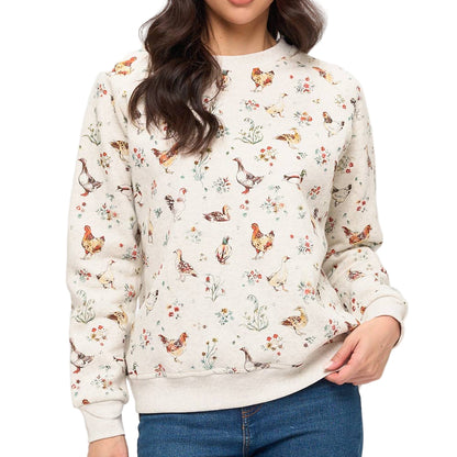 Woman wearing a sweater with a chicken pattern on a plain background